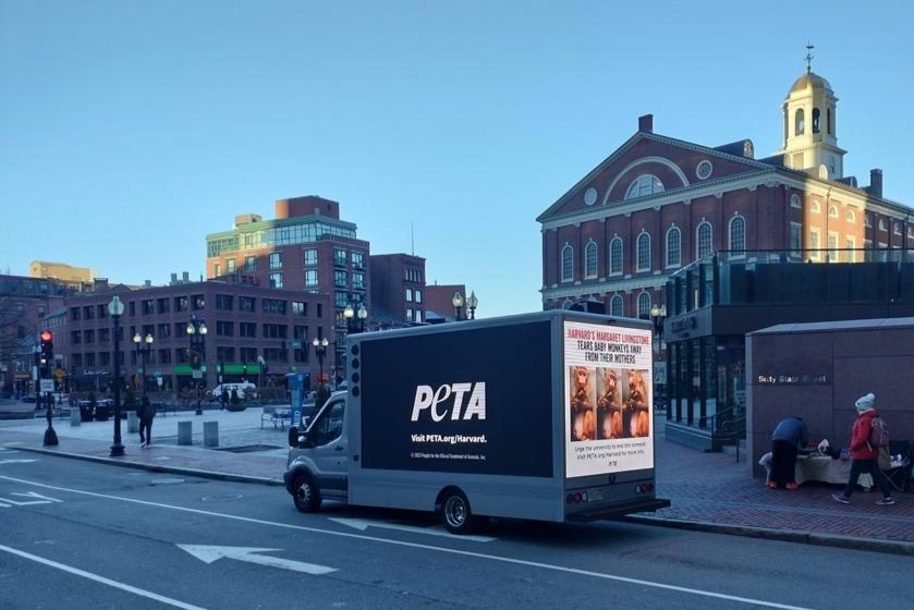 A mobile billboard truck on campus at Harvard