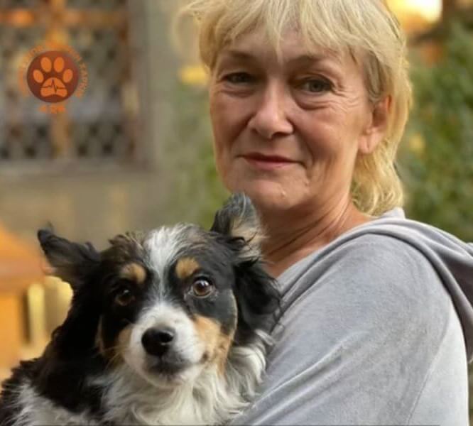 A woman and a black and white dog