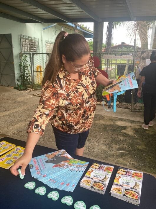 A woman picking up leaflets