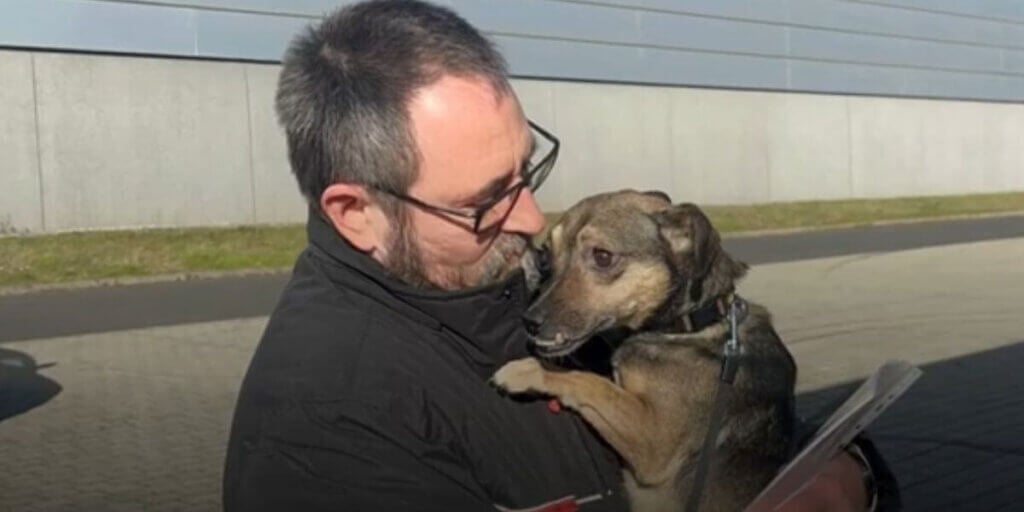 A man holding a brown dog