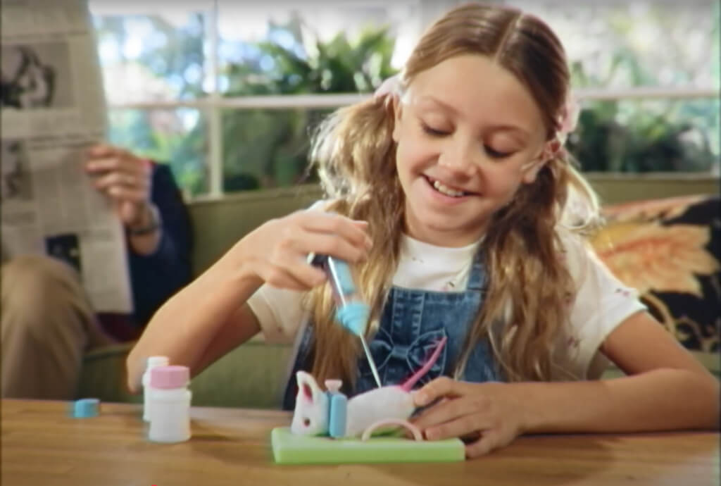 girl playing with a "science" toy for kids