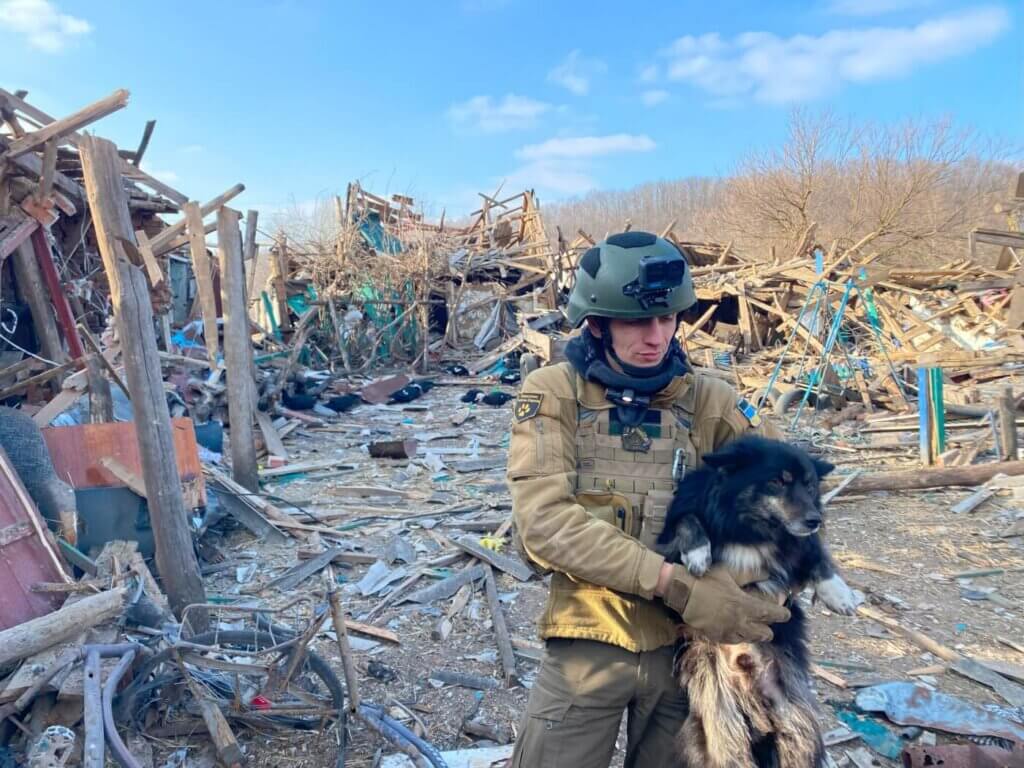 Man in armor holding dog