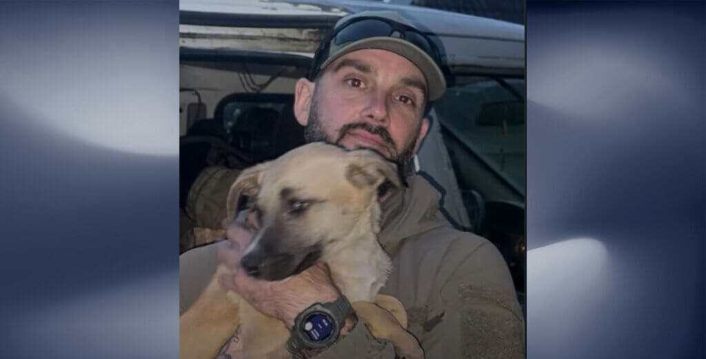 Adams holding a dog