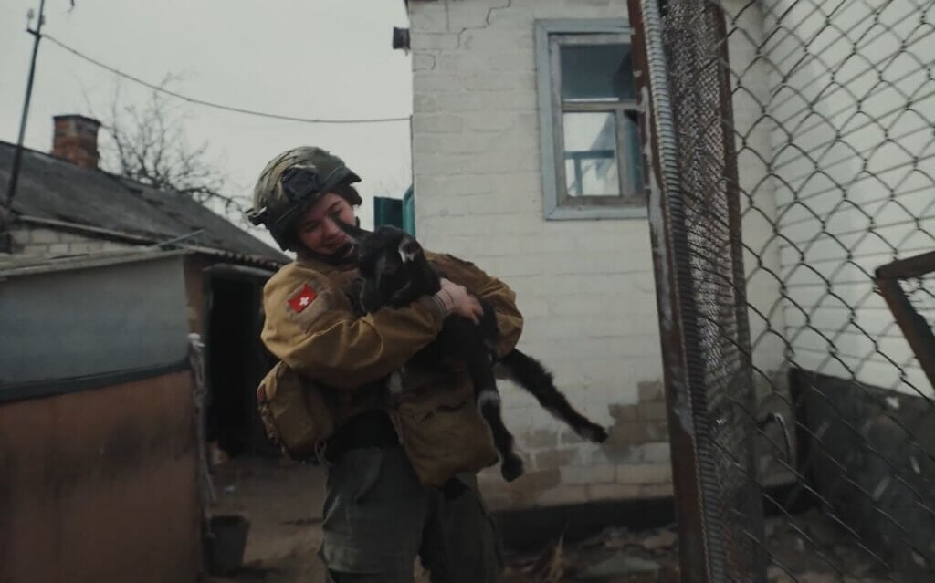 Rescuer holding goat